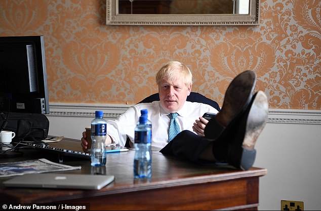 16597720-7295563-Putting_his_feet_up_My_Johnson_makes_a_call_on_speakerphone_with-a-64_1564352264013.jpg
